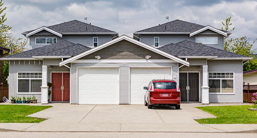 Residential,Duplex,Townhouse,With,Red,Car,Parked,On,Concret,Driveway